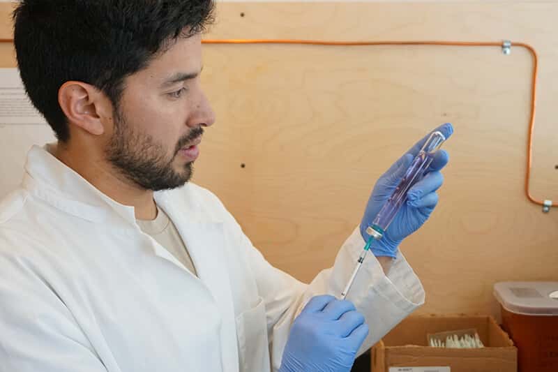 Researcher prepares sample for analysis.