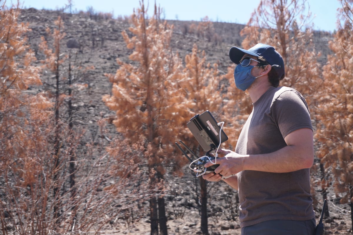 Patrick Melarkey of the Desert Research Institute flies the drone during a reseeding flight at the Loyalton Fire burn area on April 22, 2021.