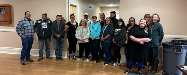 Group of educators standing together for a group picture and smiling for the camera.