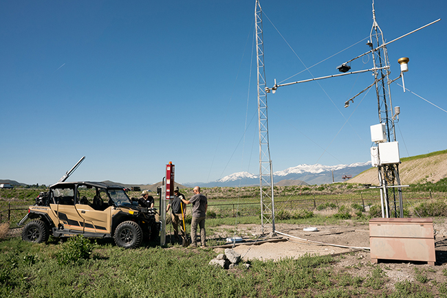 ITAP Team with an ATV in the field working on equipment. 