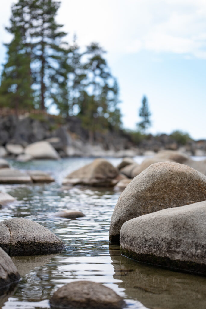 Photo closeup of the water and rocks of Lake Tahoe.