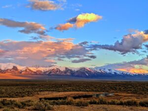 Image of mountains in Nevada topped with snow at sunset.