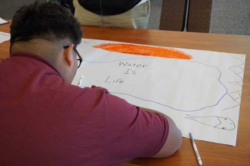 A Youth Day participant sketches his vision for Earth's future. October 2018. Credit: NWAL/DRI.