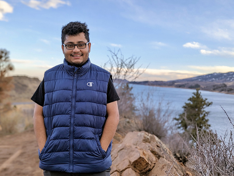 Photo of Monty with a river and mountains behind.  