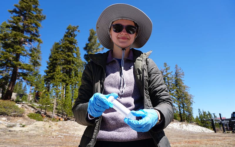 Female collects a snow algae sample