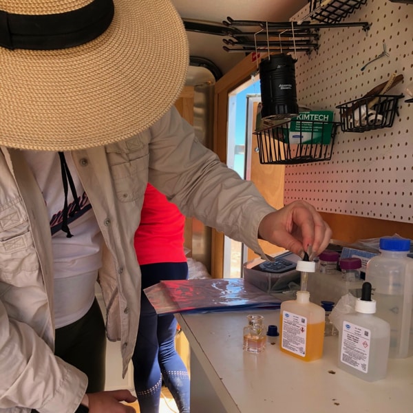 Natasha Sushenko performs field chemistries on deep borehole samples in the Funeral Mountains near Death Valley using a Hach Colorimeter