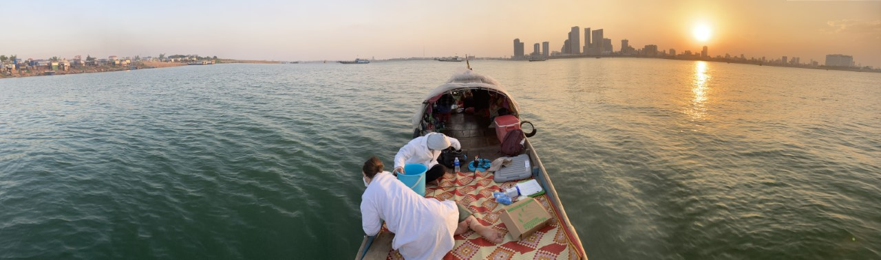 Rachel on a boat in the Mekong River, taking water samples to measure microplastics. 